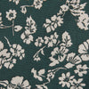 View 2 of product The Turnbull & Asser Dark Green Floral Garden Silk Tie features an elegant white floral pattern on dark green silk, shown rolled against a plain white background.