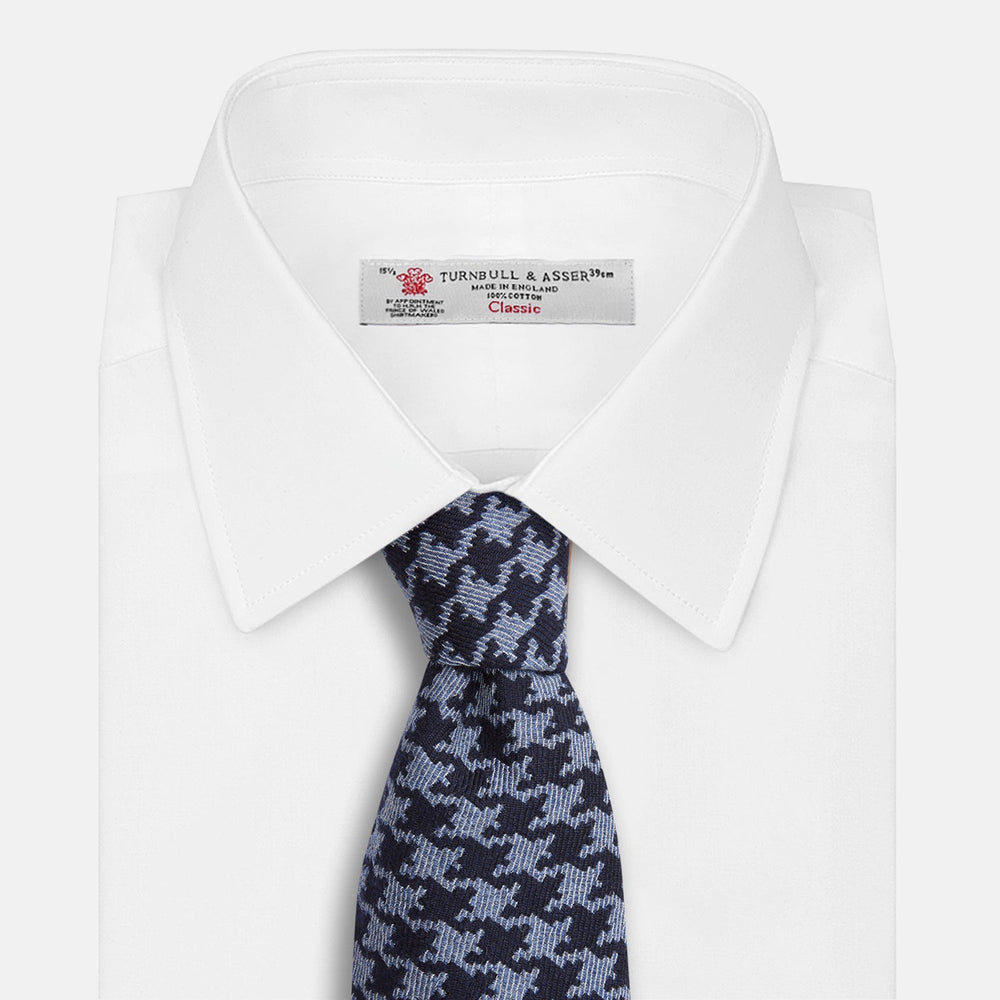 The Turnbull & Asser Navy and Blue Houndstooth Wool Blend Tie features a stylish houndstooth pattern in navy and light blue.