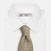 View 4 of product The Turnbull & Asser Yellow and Pale Blue Art Deco Silk Tie features interlocking yellow, blue, and black geometric shapes on white, adding a bold touch to any ensemble.