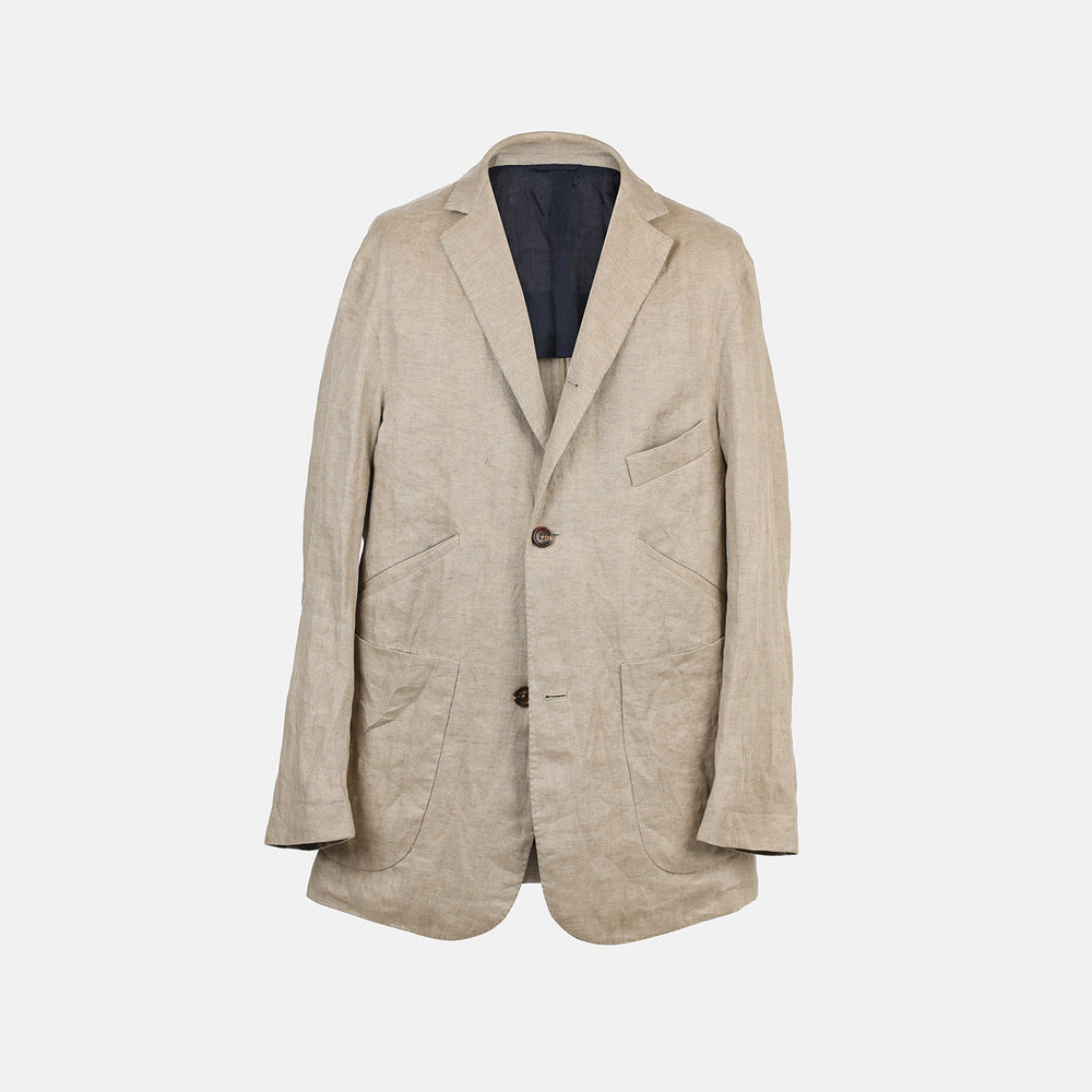 The Riviera Sand Oversized Blazer in Linen by Turnbull & Asser UK is showcased against a crisp white background. Featuring a relaxed, oversized silhouette in beige linen with two brown buttons, three front pockets, and a dark lining, this piece is perfect for effortless summer dressing.