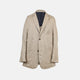 The Riviera Sand Oversized Blazer in Linen by Turnbull & Asser UK is showcased against a crisp white background. Featuring a relaxed, oversized silhouette in beige linen with two brown buttons, three front pockets, and a dark lining, this piece is perfect for effortless summer dressing.