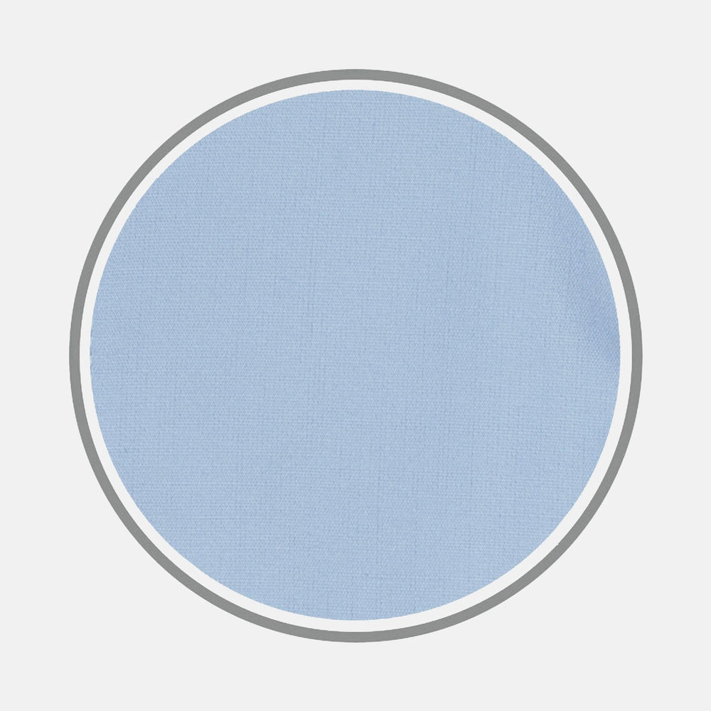 A close-up of Turnbull & Asser's BESPOKE FABRIC 0001 06, featuring light blue fabric with a fine texture for custom shirts, shown within a circular frame on a white background.