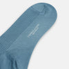 View 3 of product A single Pale Blue Mid-Length Merino Sock by Turnbull & Asser stands upright against a white background, highlighting its ribbed texture and reinforced toe and heel—showcasing the elegance of luxury merino wool.