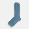 View 2 of product A single Pale Blue Mid-Length Merino Sock by Turnbull & Asser stands upright against a white background, highlighting its ribbed texture and reinforced toe and heel—showcasing the elegance of luxury merino wool.