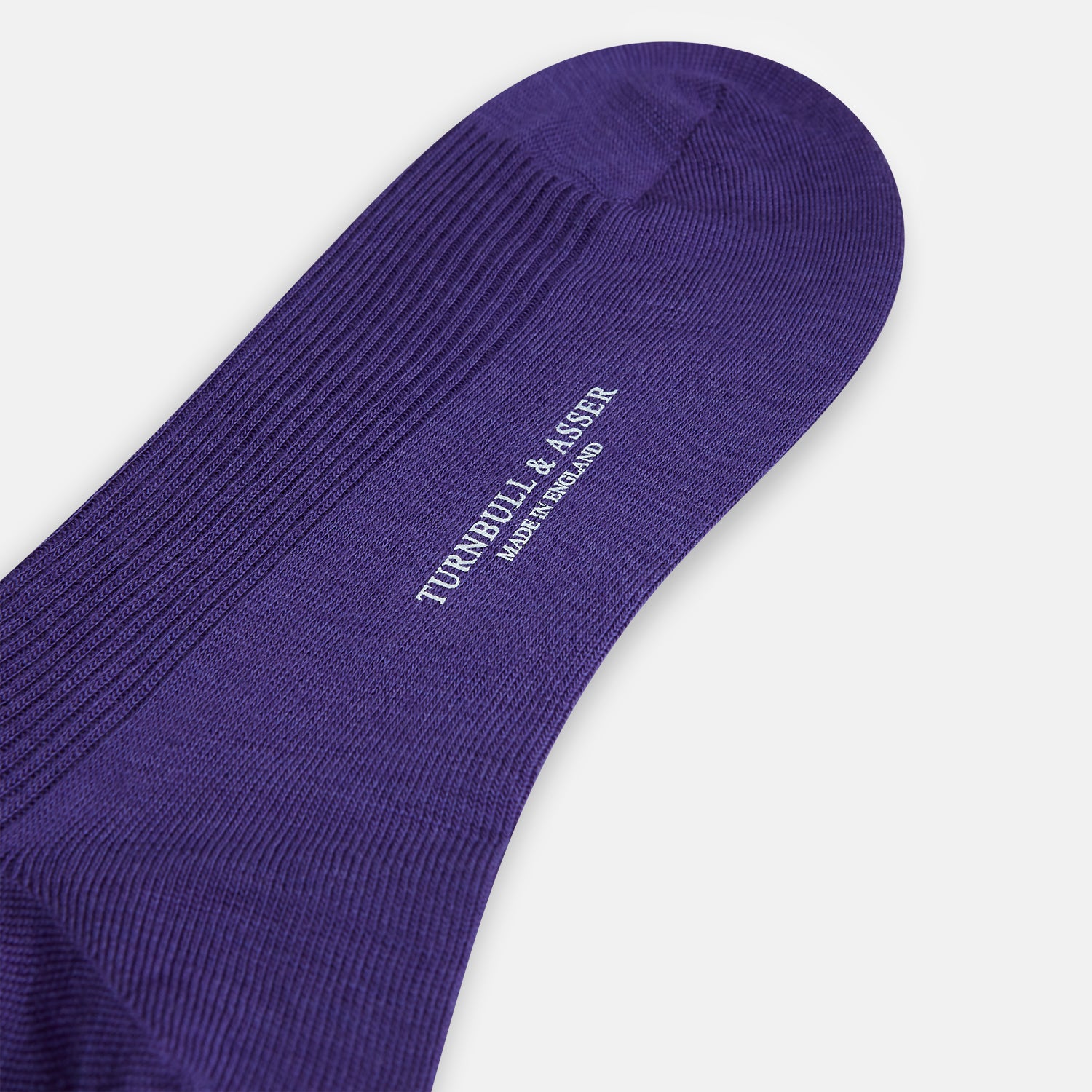 View 3 of product The Turnbull & Asser Violet Mid-Length Merino Socks, crafted from luxurious merino wool, feature a knee-high ribbed design and are shown upright against a plain white background.