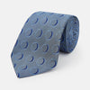 View 1 of product The Turnbull & Asser Die Another Day Circle Silk Tie, as seen on James Bond, features large dark blue ovals on a lighter blue background.
