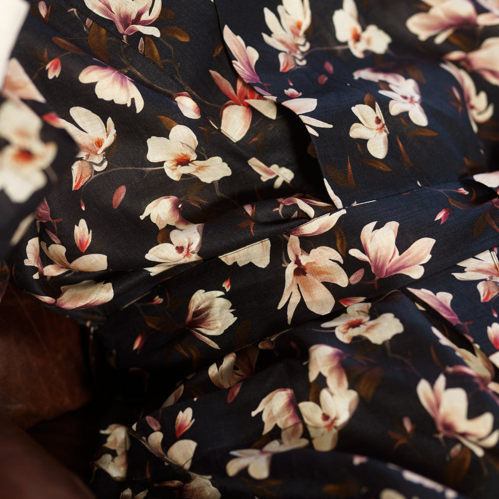The Turnbull & Asser Navy Floral Pattern Linen Hayhurt Kimono Gown is a knee-length, long-sleeved gown with a floral print and a matching fabric belt tied at the waist.