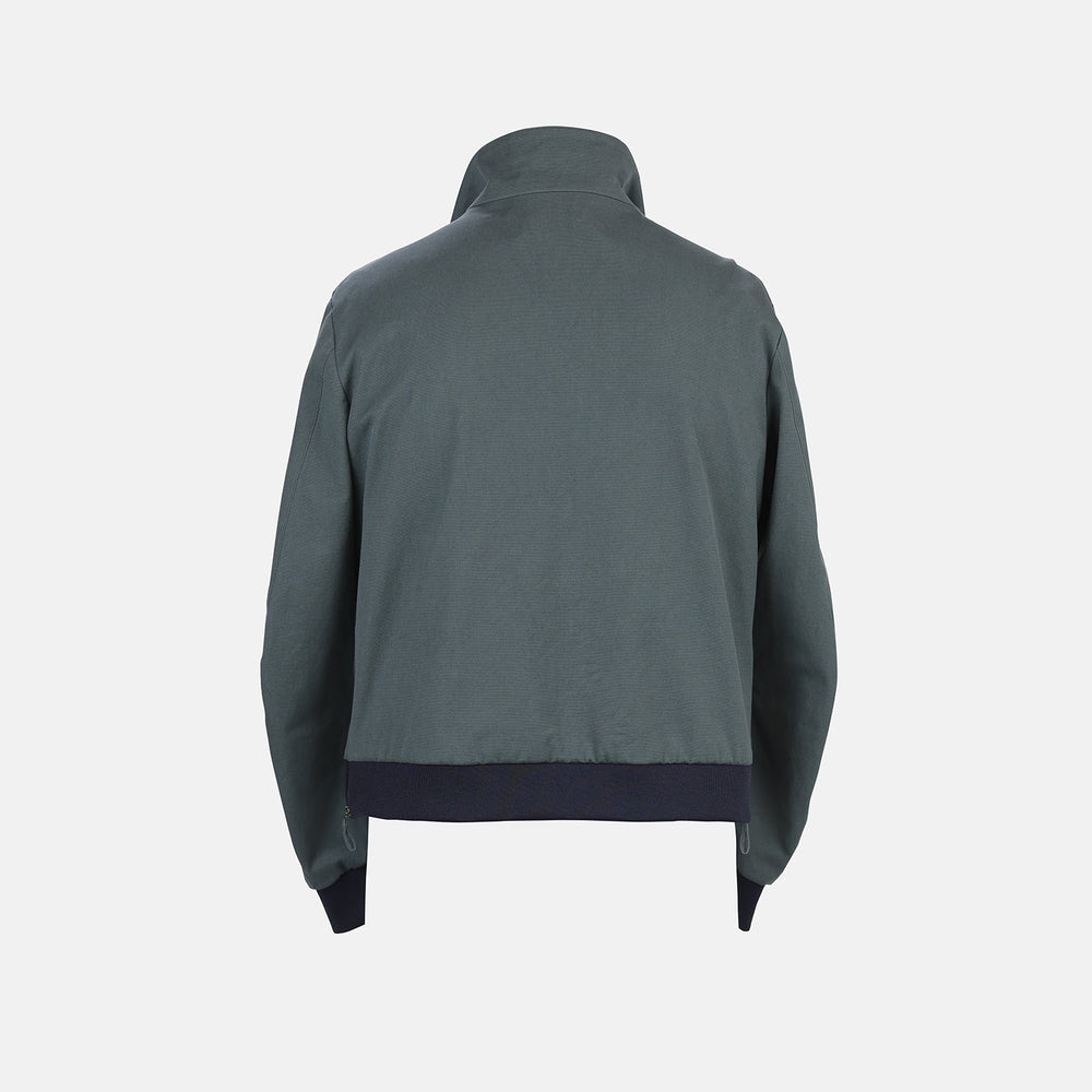 A Fairway Ash Grey Driving Jacket in Cotton by Turnbull & Asser UK, featuring a zip-up front, high collar, chest and side zip pockets, and dark ribbed cuffs and waistband; crafted from lightweight cotton for comfort and style, displayed on a plain white background.