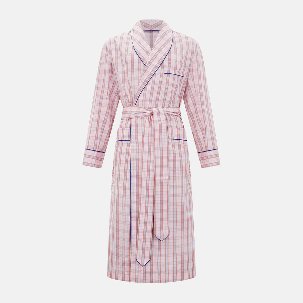 The Pink Check Cotton Gown by Turnbull & Asser UK is a long cotton dressing gown in a pink check pattern, featuring a belted waist, notched collar, long sleeves, and blue trim along the edges and pocket—perfect for relaxing in style.