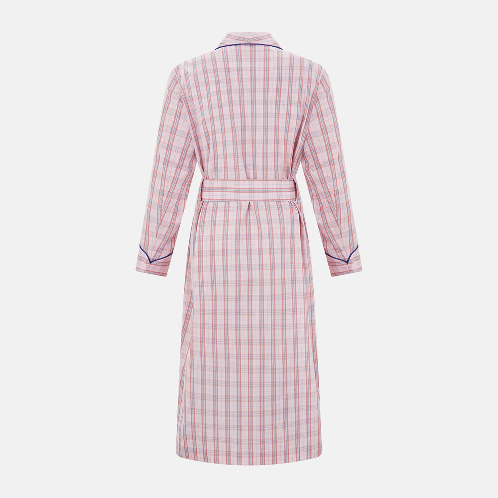 The Pink Check Cotton Gown by Turnbull & Asser UK is a long cotton dressing gown in a pink check pattern, featuring a belted waist, notched collar, long sleeves, and blue trim along the edges and pocket—perfect for relaxing in style.