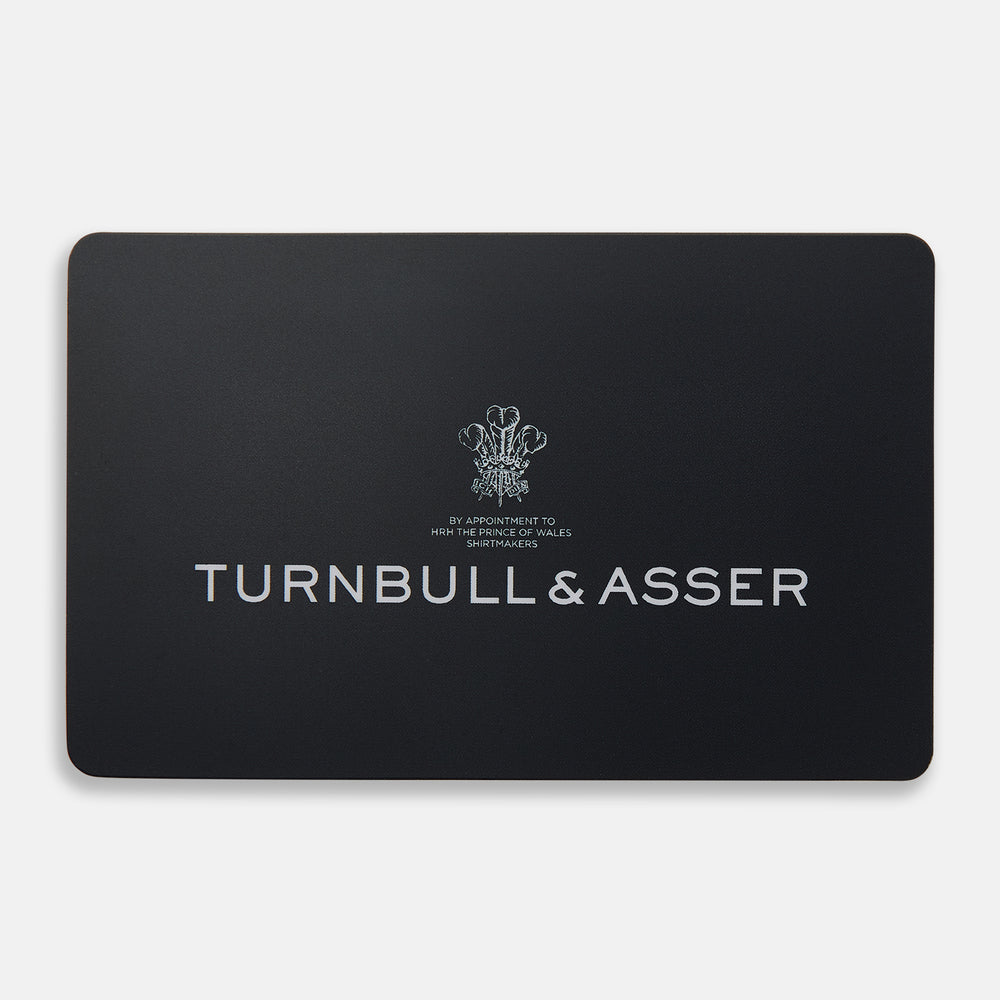 A sleek black Turnbull & Asser E-Voucher card displays the brand name in white, a small emblem above it, and the words "By Appointment to H.R.H. The Prince of Wales Shirtmakers" beneath the emblem.