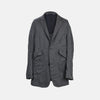 View 1 of product The Riviera Ash Oversized Blazer in Linen by Turnbull & Asser UK, showcased against a plain white background, features a single-breasted design in dark gray linen—ideal for summer tailoring—with two front buttons and large flap pockets. This jacket seamlessly combines classic style with breathable comfort.