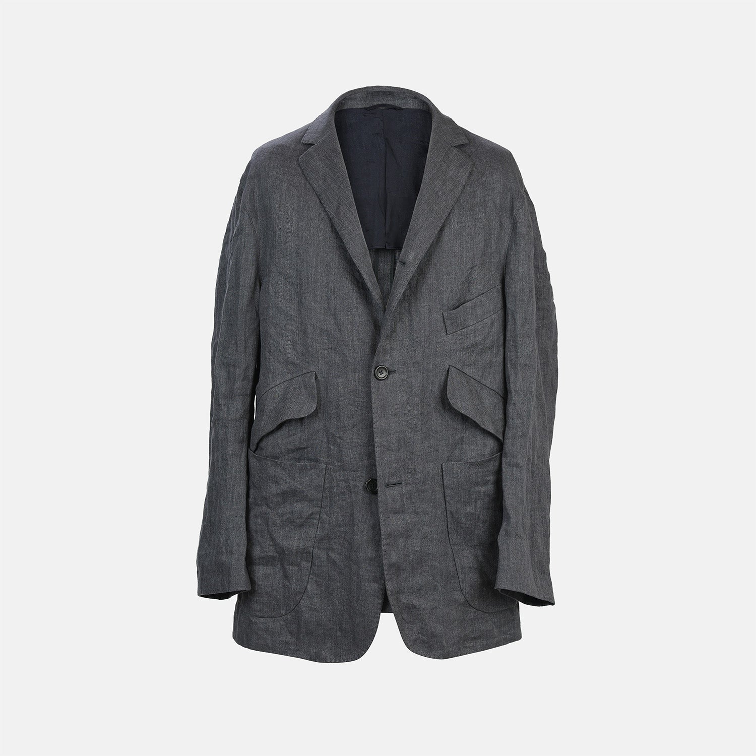 View 1 of product The Riviera Ash Oversized Blazer in Linen by Turnbull & Asser UK, showcased against a plain white background, features a single-breasted design in dark gray linen—ideal for summer tailoring—with two front buttons and large flap pockets. This jacket seamlessly combines classic style with breathable comfort.