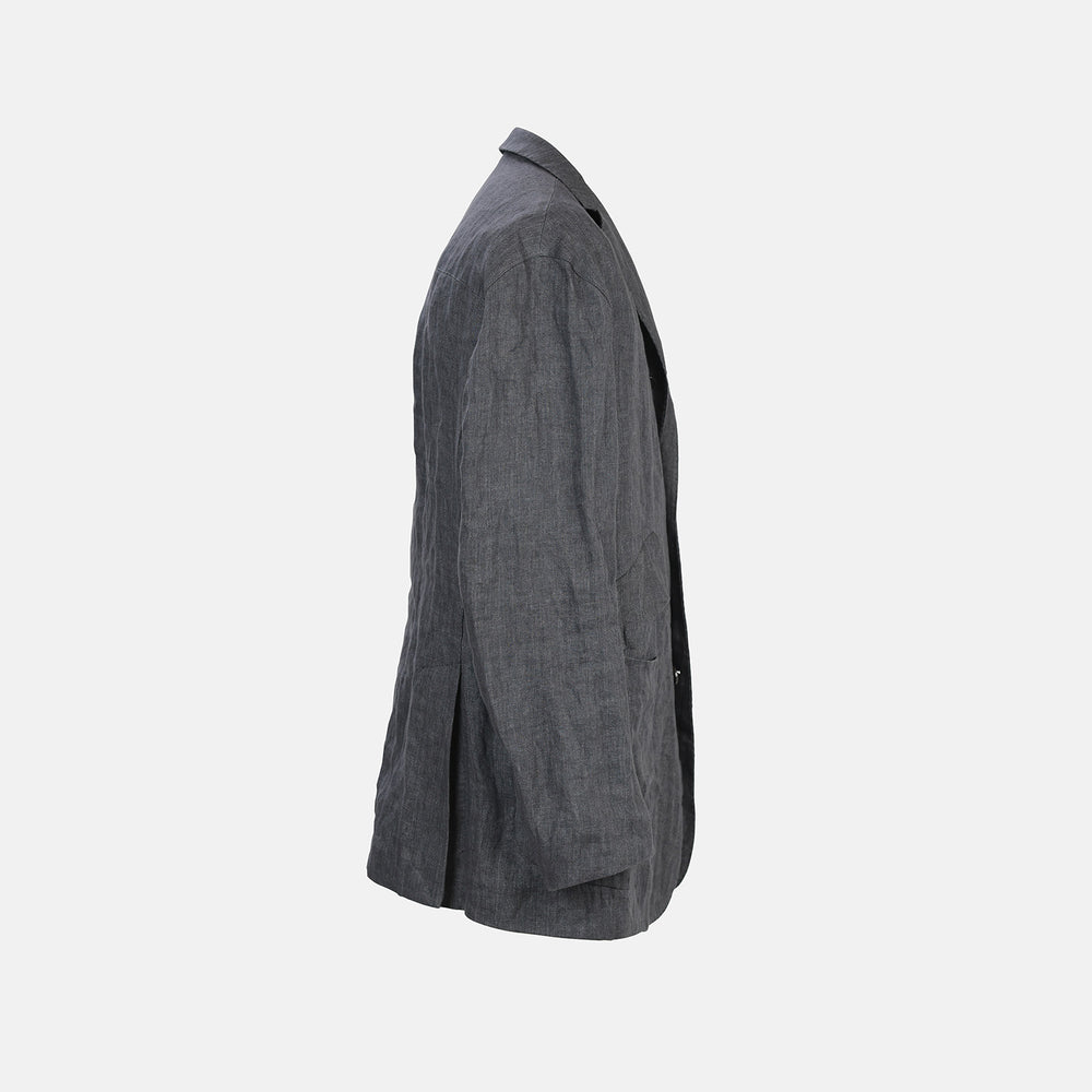 The Riviera Ash Oversized Blazer in Linen by Turnbull & Asser UK, showcased against a plain white background, features a single-breasted design in dark gray linen—ideal for summer tailoring—with two front buttons and large flap pockets. This jacket seamlessly combines classic style with breathable comfort.