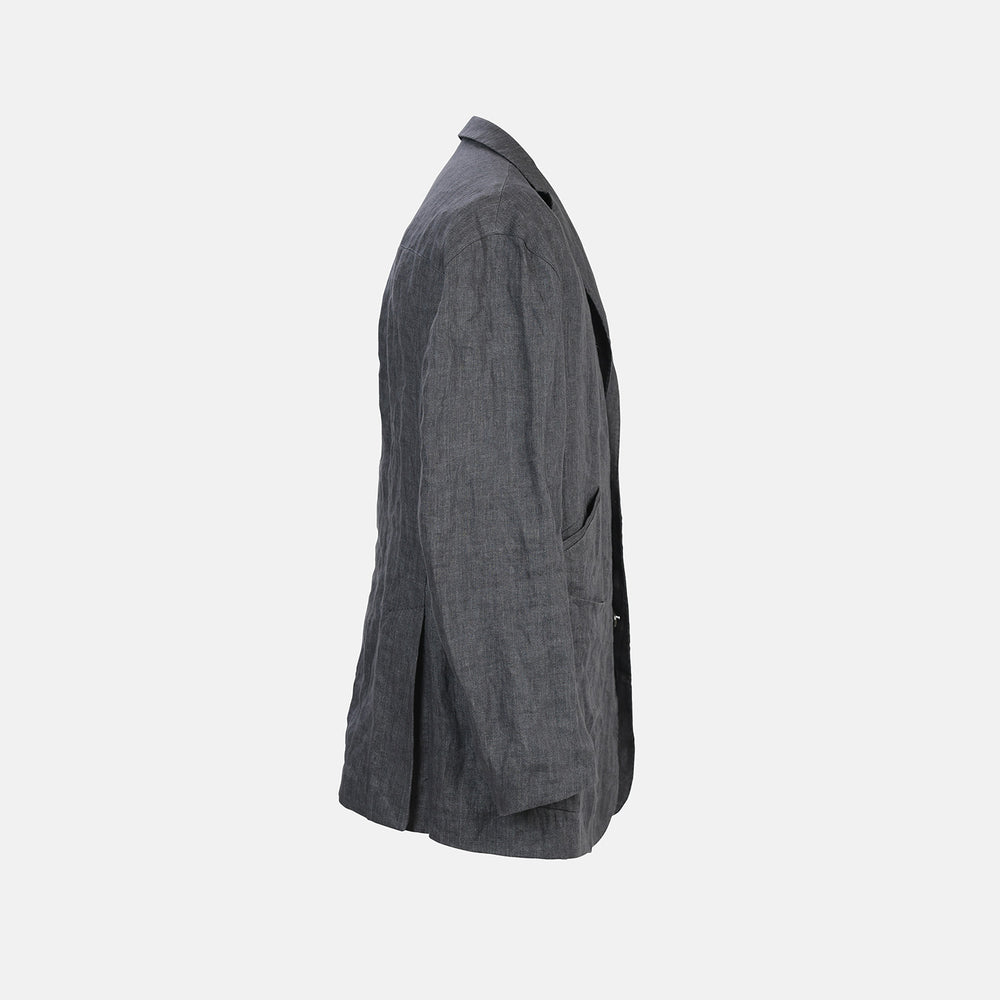 The Riviera Ash Oversized Blazer in Linen by Turnbull & Asser UK, showcased against a plain white background, features a single-breasted design in dark gray linen—ideal for summer tailoring—with two front buttons and large flap pockets. This jacket seamlessly combines classic style with breathable comfort.