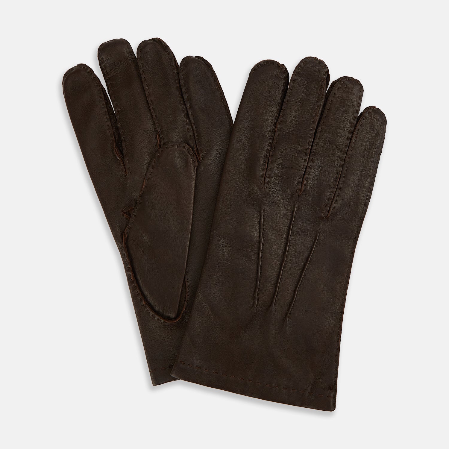 View 1 of product The Turnbull & Asser UK Dark Brown Leather Hand-Stitched Gloves are displayed on a white background, with one glove overlapping the other.