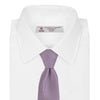 View 2 of product The Turnbull & Asser Lilac Houndstooth Silk Tie features a subtle houndstooth pattern and elegant silk weave—ideal for elevating your favorite office shirt. Displayed rolled on a white background.