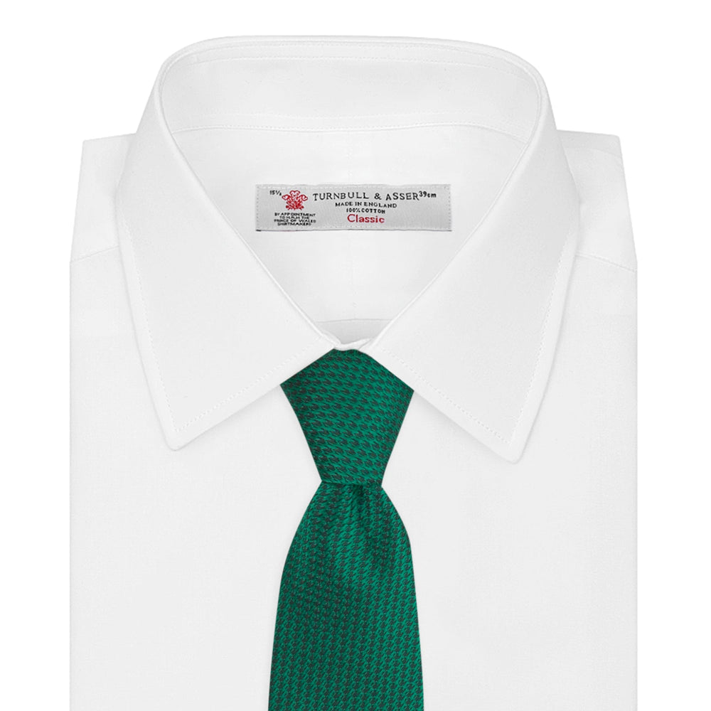 The Turnbull & Asser Green Lace Silk Tie, featuring a textured lace weave, is neatly rolled and displayed on a white background—an elegant, versatile accessory for any wardrobe.
