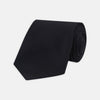 View 1 of product A neatly rolled Turnbull & Asser Navy Grenadine Silk Tie with a textured, knitted appearance is displayed on a white background.