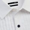 View 3 of product The Casino Royale White Dress Shirt in Cotton by Turnbull & Asser UK is a long-sleeve white dress shirt, crafted from crisp white cotton poplin with a pleated bib front, black buttons, and a classic collar, shown laid flat on a white background.