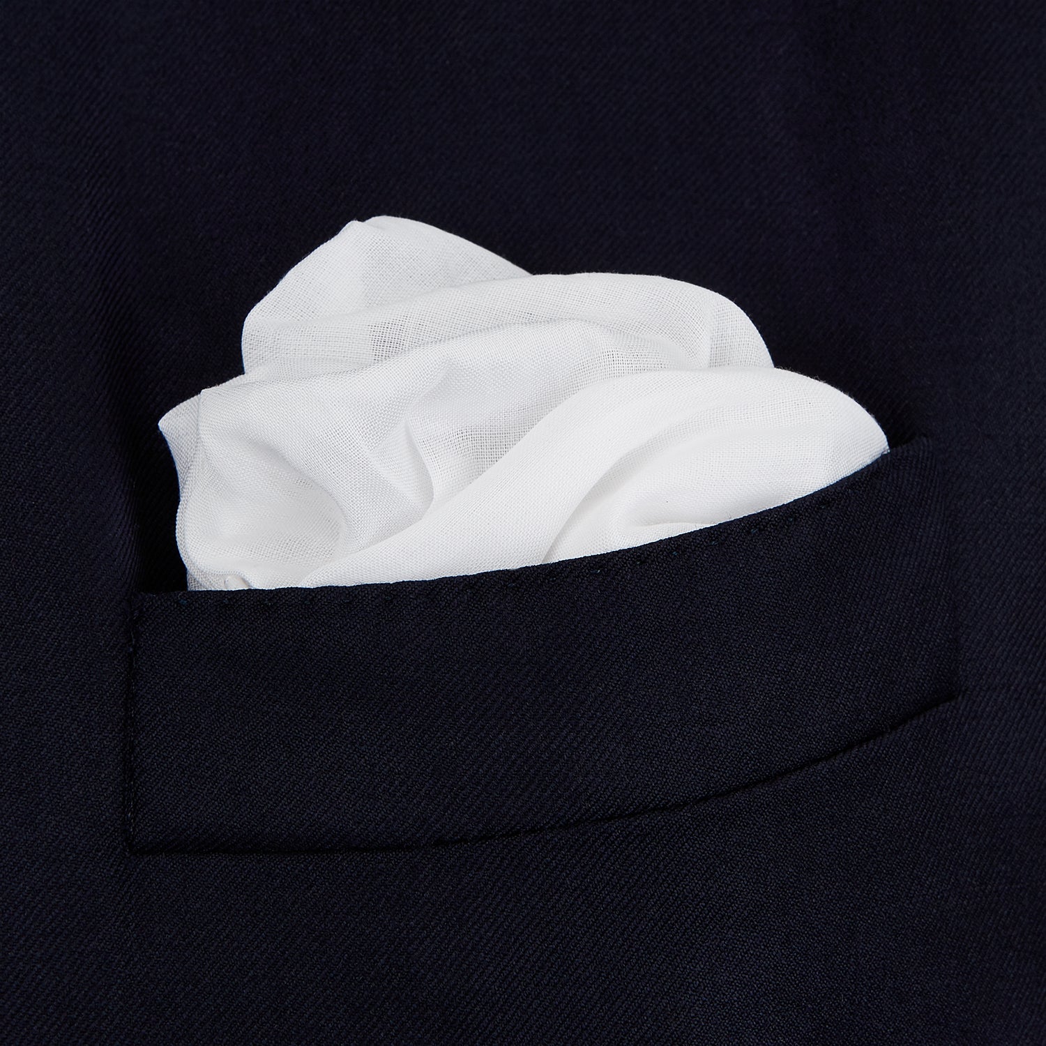View 4 of product The James Bond Voile Pocket Square by Turnbull & Asser, in plain white with hand-rolled edges, is neatly folded and laid flat on a white background—a classic accessory for timeless style.