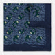 The Navy Blue Wave Silk Pocket Square by Turnbull & Asser UK showcases a playful motif of green and white fish swimming among wavy blue lines, with the brand’s name printed in white in the corner.