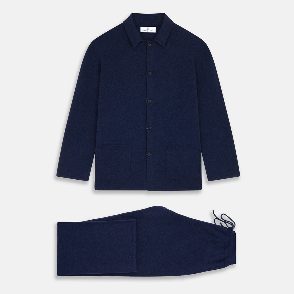 The Turnbull & Asser Navy Cashmere Knitted Traditional Pyjama Set features a long-sleeve camp collar shirt with front pockets and matching drawstring pants, offering an elevated twist on classic loungewear.