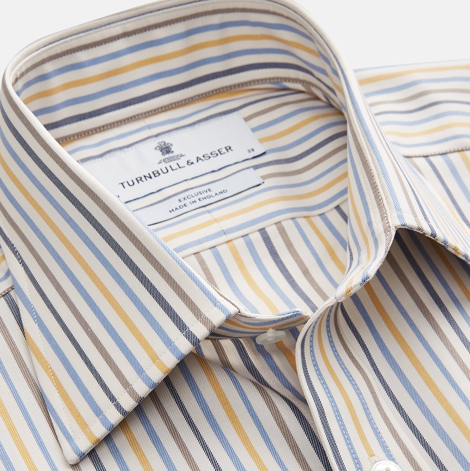 View 2 of product The Turnbull & Asser Yellow Multi Stripe Regular Fit Shirt features a T&A collar, 3 button cuffs, and thin blue, yellow, and light brown stripes on white for a classic formal look.