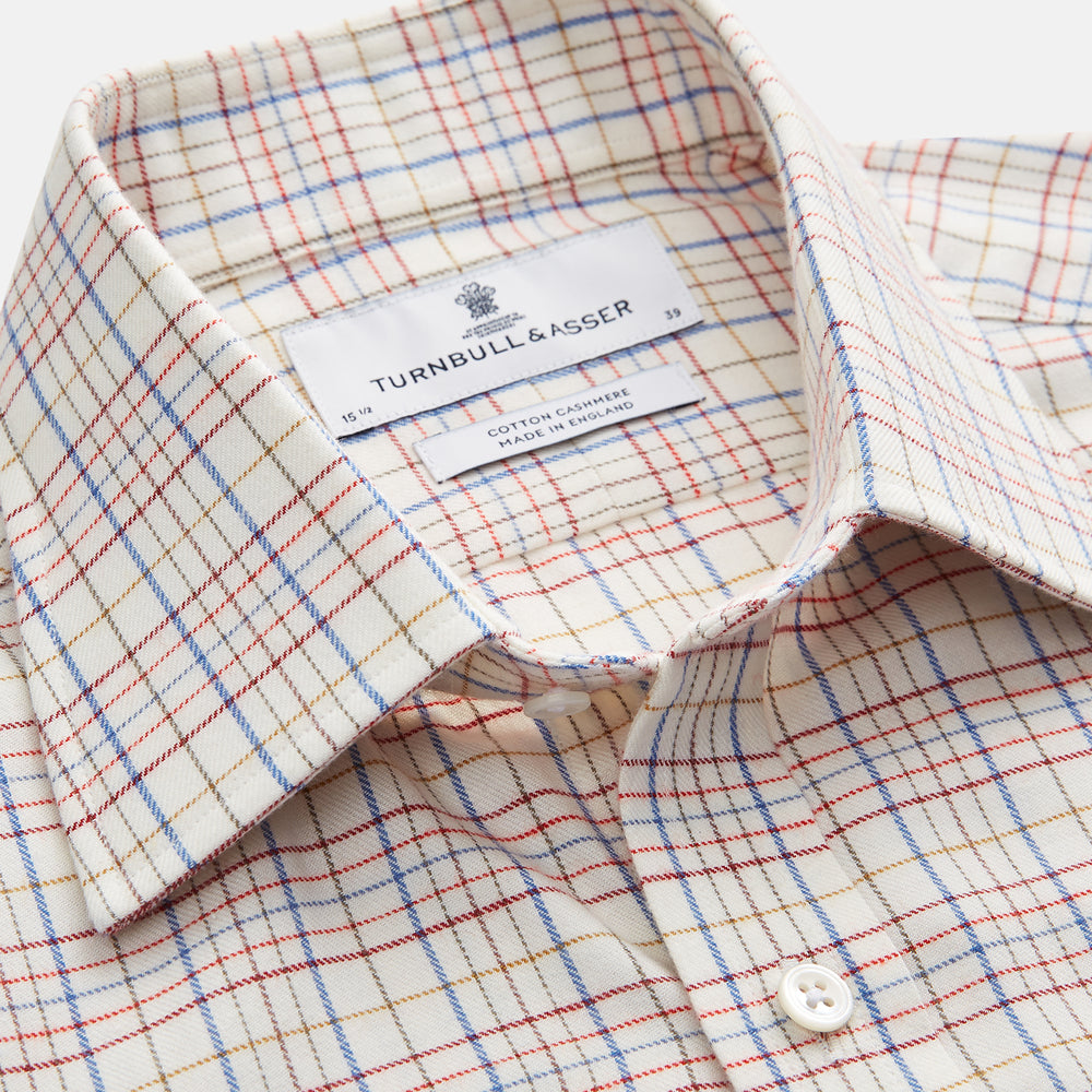 The Turnbull & Asser Red Multi Check Regular Fit Cotton-Cashmere Shirt features a T&A collar, 3 button cuffs, and a multicolored check pattern on white, shown laid flat against a white surface.