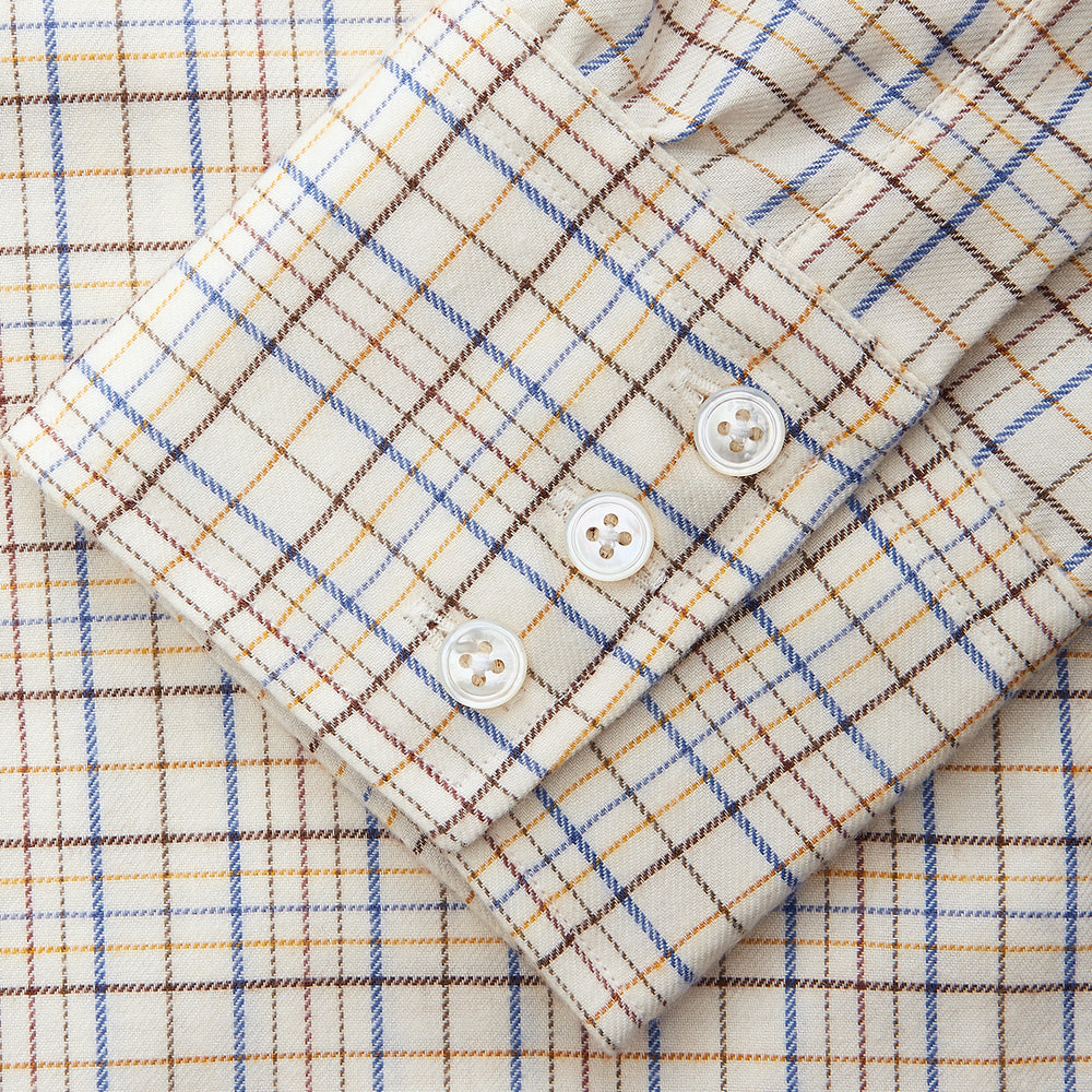 The Turnbull & Asser Brown Multi Check Regular Fit Cotton-Cashmere Shirt features a white base with blue, yellow, and brown checks, T&A collar, and 3 button cuffs for a smart-casual look.