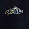View 2 of product The Blue and Yellow Paisley Tiger Silk Pocket Square by Turnbull & Asser features a light blue base with paisley, elephants, tigers, and floral motifs—highlighted by a blue border. An elegant choice to pair with any Turnbull shirt.