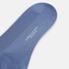 View 3 of product A single Powder Blue Mid-Length Merino Sock by Turnbull & Asser stands upright against a white background, showcasing its smooth texture and subtle vertical lines, with a length that reaches just below the knee.