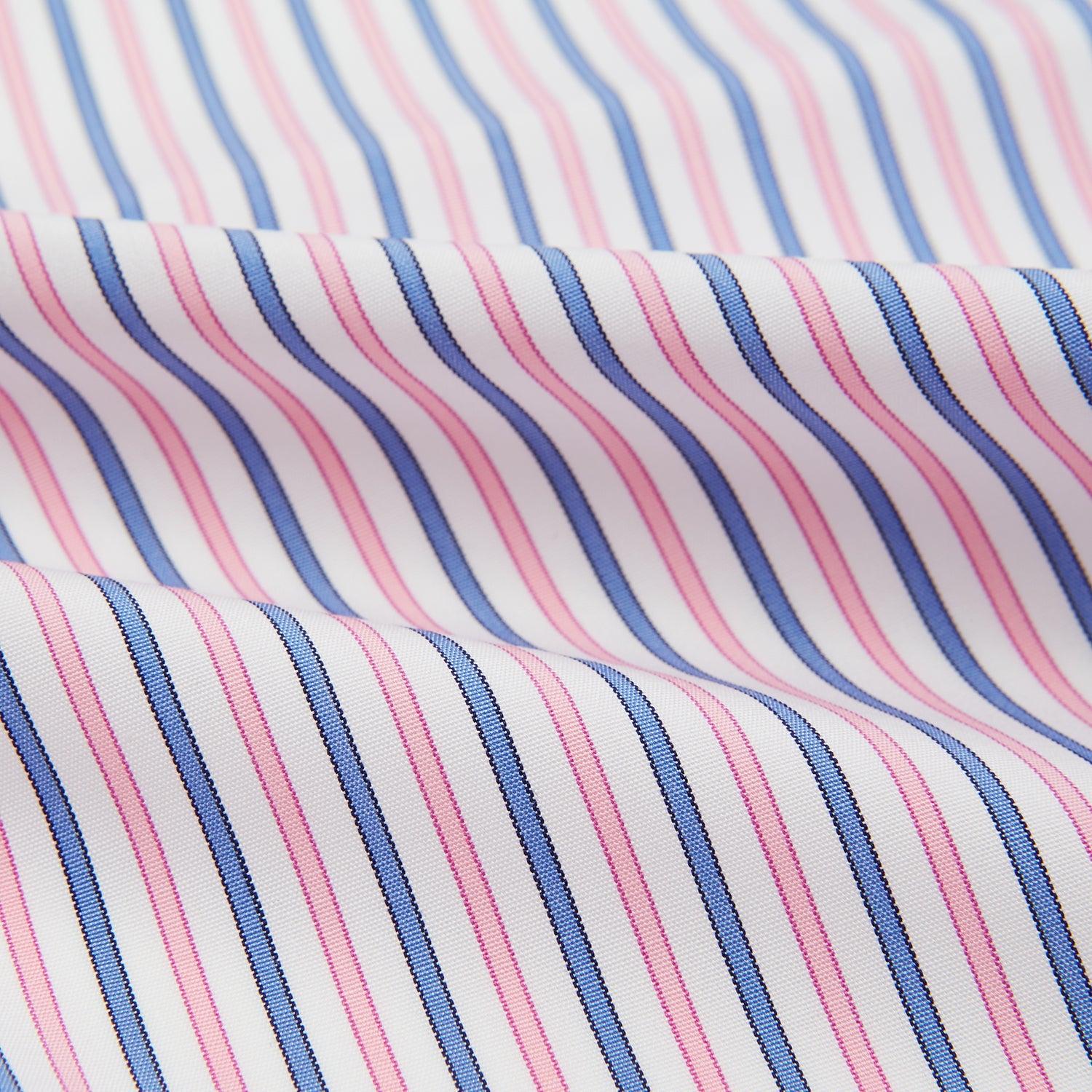 View 4 of product The Turnbull & Asser Hand Rolled Pink and Blue Track Stripe Handkerchief is a cotton square with blue, pink, and purple stripes on white, finished with a hand-rolled pink edge—an elegant addition to formal attire.