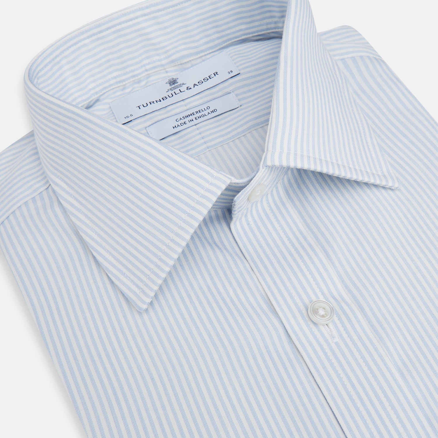 View 2 of product The Turnbull & Asser Blue and White Pencil Stripe Cashmerello Mayfair Shirt features a pointed collar, white buttons, buttoned cuffs, and long sleeves. Crafted from a cotton-cashmere blend, it’s displayed flat on a white background.