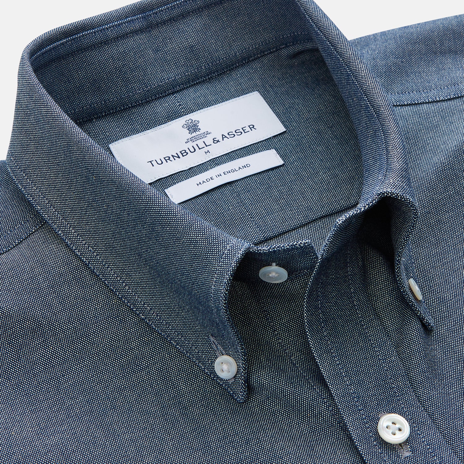 View 2 of product The Turnbull & Asser Blue Chambray Weekend Fit Nevis Cotton Shirt features a Dorset collar, 1-button cuffs, and smart-casual tailoring, shown laid flat on a white background.