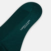 View 3 of product A single Turnbull & Asser Petrol Green Mid-Length Merino Sock stands upright on a plain white background, showcasing its ribbed texture and signature rounded toe and heel.