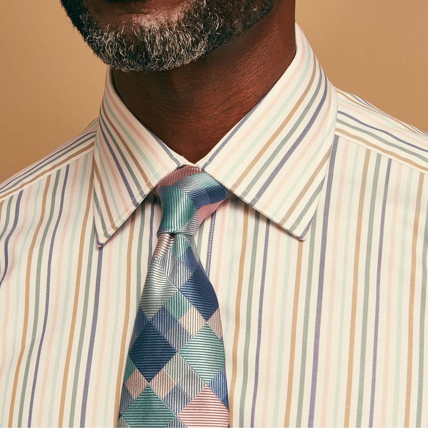 View 2 of product The Green Multi Pixel Silk Tie by Turnbull & Asser features a checked pattern in blue, teal, and pink on a light background, with diagonal stripes in each square for added texture.