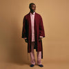 View 3 of product The Turnbull & Asser Pink Candy Stripe Cotton Traditional Pyjamas feature long sleeves, pants, vertical pink candy stripes, a camp collar shirt with buttons, chest pocket, and navy trim on the pocket and cuffs.