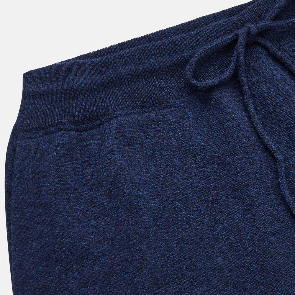 The Turnbull & Asser Navy Cashmere Knitted Traditional Pyjama Set features a long-sleeve camp collar shirt with front pockets and matching drawstring pants, offering an elevated twist on classic loungewear.
