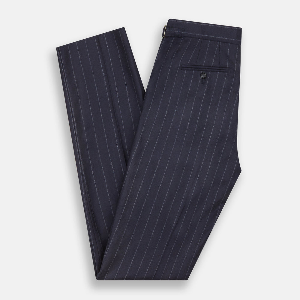 The Navy Pinstripe Henry Trousers by Turnbull & Asser feature vertical white stripes, a tailored fit, button closure, and belt loops. Crafted from a wool cashmere blend, they are shown against a plain white background.
