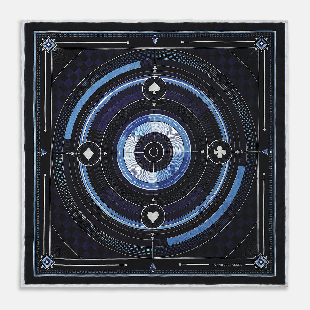 Presenting the Casino Royale Midnight Blue Target Pocket Square in Silk from Turnbull & Asser UK—a luxurious silk square scarf adorned with concentric circles in rich midnight blue and black, accented by playing card suit symbols (spade, diamond, club, heart) at each cardinal point and striking geometric patterns in the corners. This elegant accessory is perfect for adding a touch of sophisticated intrigue to your ensemble.