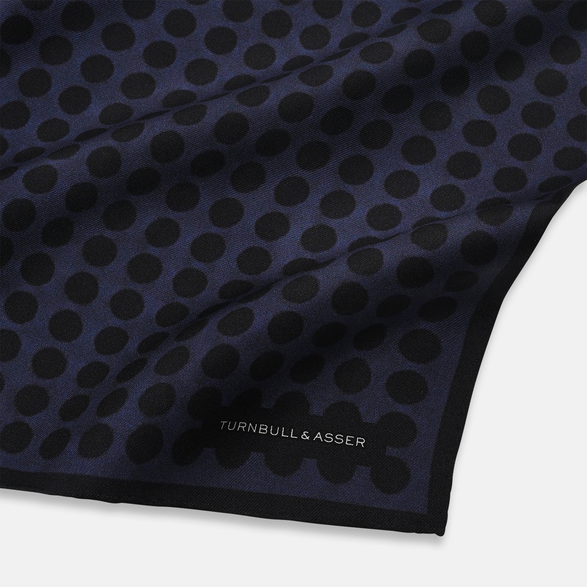View 2 of product The Casino Royale Midnight Blue Straight Flush Pocket Square in Silk by Turnbull & Asser UK features a rich midnight blue background adorned with a black dotted pattern and showcases five playing cards—the 10, 9, 8, 7, and 6 of spades—arranged in a row at the center for an elegant straight flush design inspired by classic casino style.