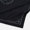 View 2 of product Introducing the Casino Royale Midnight Blue Crest Pocket Square in Silk from Turnbull & Asser UK—a midnight blue silk pocket square bordered in white, featuring playing card suit symbols at each corner and a central motif depicting the 10, J, Q, and K of spades beneath a crown and laurel. Perfect as a sophisticated Casino Royale or Bond tuxedo accessory, with “Turnbull & Asser” elegantly displayed in the lower right.