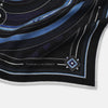 View 2 of product Presenting the Casino Royale Midnight Blue Target Pocket Square in Silk from Turnbull & Asser UK—a luxurious silk square scarf adorned with concentric circles in rich midnight blue and black, accented by playing card suit symbols (spade, diamond, club, heart) at each cardinal point and striking geometric patterns in the corners. This elegant accessory is perfect for adding a touch of sophisticated intrigue to your ensemble.