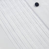 View 8 of product The Casino Royale White Dress Shirt in Cotton by Turnbull & Asser UK is a long-sleeve white dress shirt, crafted from crisp white cotton poplin with a pleated bib front, black buttons, and a classic collar, shown laid flat on a white background.