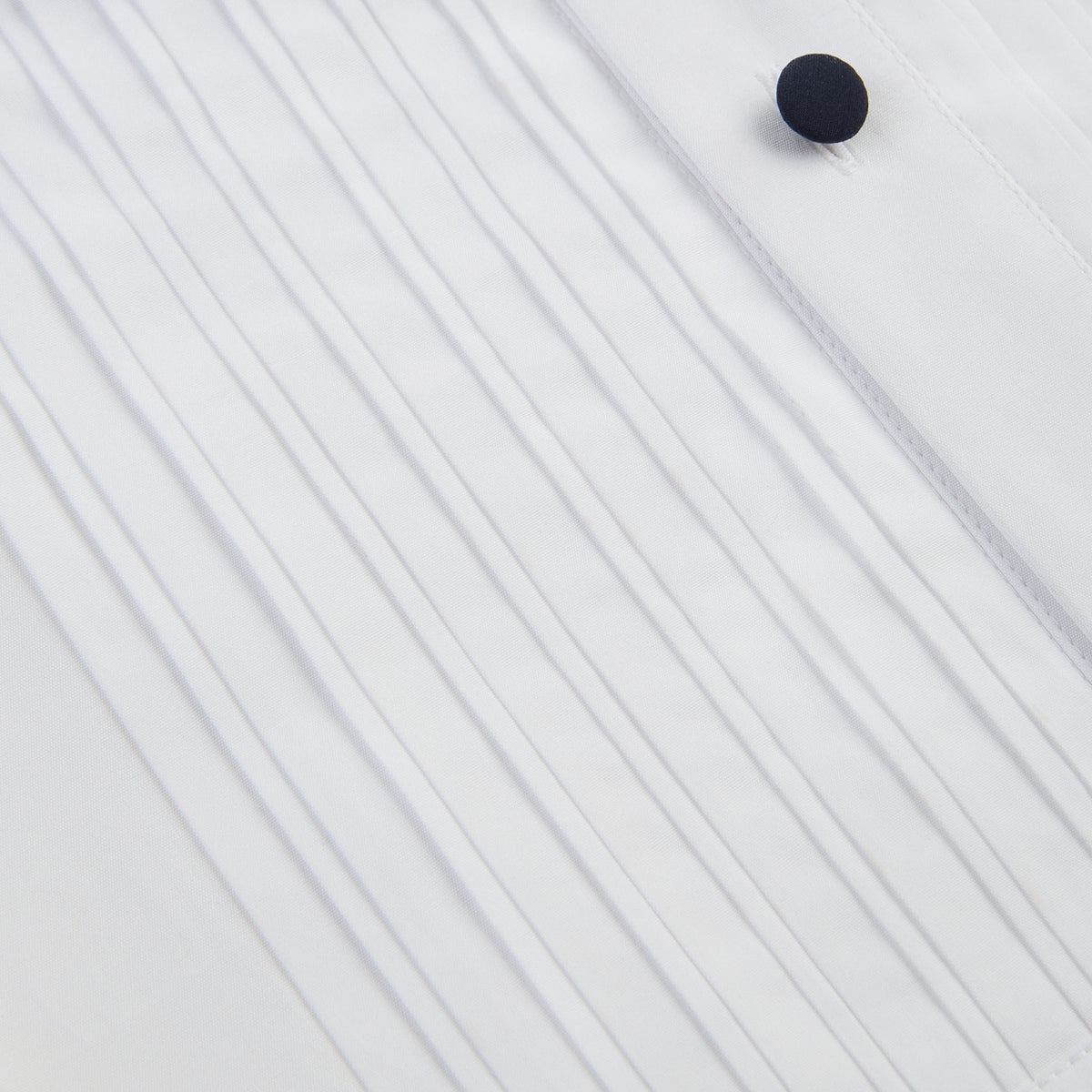View 8 of product The Casino Royale White Dress Shirt in Cotton by Turnbull & Asser UK is a long-sleeve white dress shirt, crafted from crisp white cotton poplin with a pleated bib front, black buttons, and a classic collar, shown laid flat on a white background.