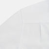 View 5 of product The Casino Royale White Dress Shirt in Cotton by Turnbull & Asser UK is a long-sleeve white dress shirt, crafted from crisp white cotton poplin with a pleated bib front, black buttons, and a classic collar, shown laid flat on a white background.
