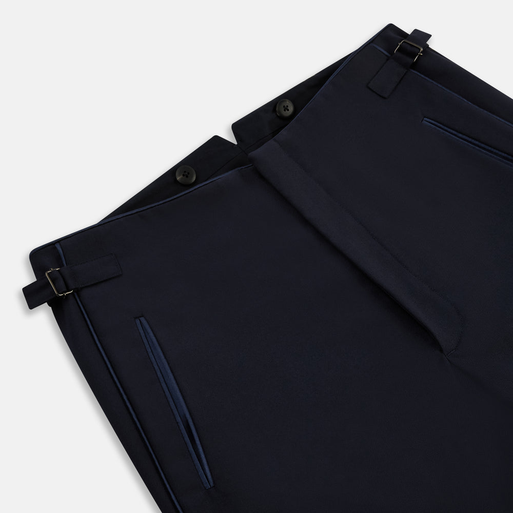 The Casino Royale Midnight Blue Tuxedo Trousers in Wool by Turnbull & Asser UK are shown from the back, expertly crafted from virgin wool in a signature tuxedo style, featuring two buttoned back pockets and adjustable side tabs at the waistband.