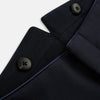 View 7 of product The Casino Royale Midnight Blue Tuxedo Trousers in Wool by Turnbull & Asser UK are shown from the back, expertly crafted from virgin wool in a signature tuxedo style, featuring two buttoned back pockets and adjustable side tabs at the waistband.