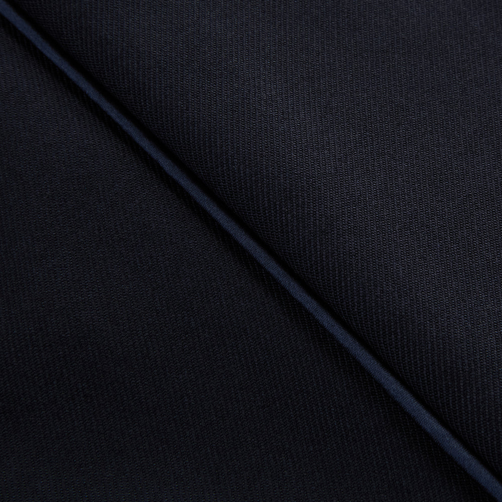 The Casino Royale Midnight Blue Tuxedo Trousers in Wool by Turnbull & Asser UK are shown from the back, expertly crafted from virgin wool in a signature tuxedo style, featuring two buttoned back pockets and adjustable side tabs at the waistband.